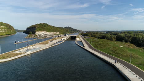 AERIAL:-Shot-of-a-lock-in-a-canal-on-a-sunny-day