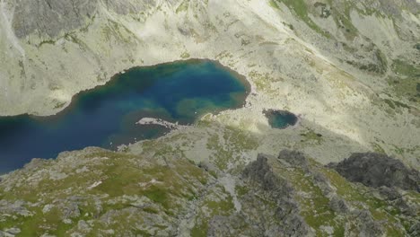 Drone-Flying-Over-Tourists-Near-The-Tatra-Mountain-Gorge-Of-Slovakia-On-A-Bright-Sunny-Day---Aerial-Shot