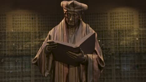 Holzstatue-Im-Innenbereich-Von-Erasmus-Von-Rotterdam,-Der-Stehend-Ein-Buch-Liest