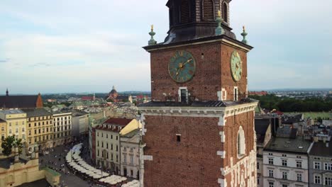 Beautiful-clock-of-the-town-hall-tower-in-main-square-of-Krakow-Old-Town-with-the-view-of-apartments-in-background