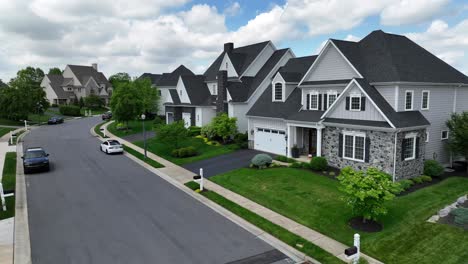 Aerial-flight-over-street-with-parked-cars-in-luxury-neighborhood