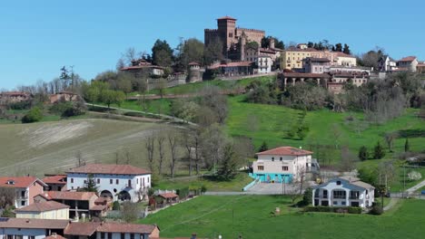 rising-drone-video-to-meet-Gabiano,-Italy,-and-view-the-ancient-cultivated-farmland-beyond