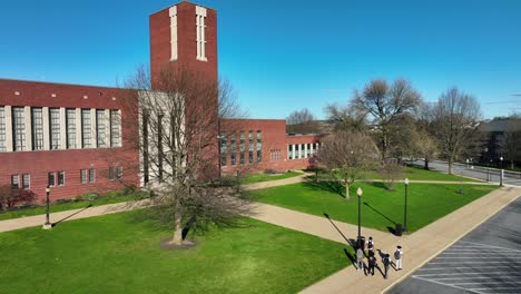 High-school-students-walking-on-sidewalk-in-front-of-American-city-public-school