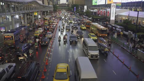 Bangkok's-notorious-traffic,-congested-roads,-dense-clusters-of-cars,-motorbikes-weaving-through-tight-spaces,-and-crowded-intersections,-highlighting-the-city's-bustling-and-chaotic-transport-system