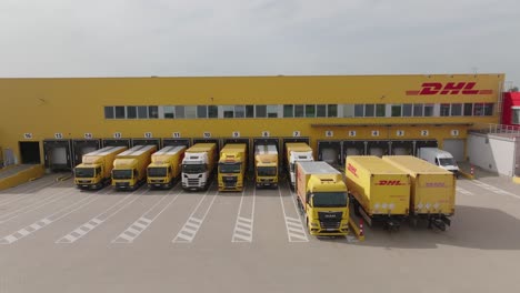 DHL-delivery-and-distribution-packaging-warehouse-with-delivery-trucks-and-vans