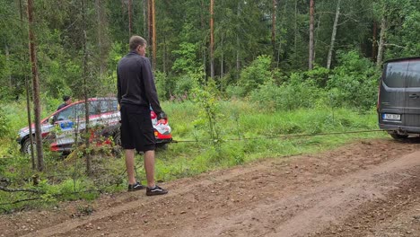 Minivan-Versucht,-WRC-Auto-Herauszuziehen,-Das-Von-Der-Straße-Abgekommen-Und-Zwischengespeichert-War