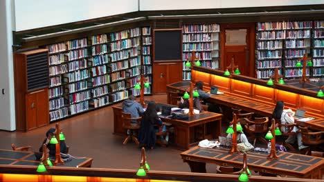 People-studying-and-learning-within-the-grand-La-Trobe-Reading-Room-at-the-State-Library-Victoria,-in-Melbourne's-bustling-central-business-district,-concept-shot-of-Australian-students-HECS-debt