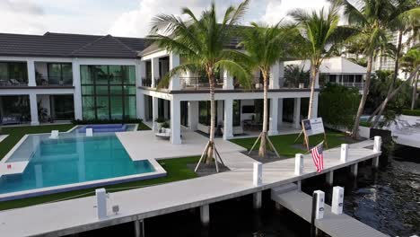 Aerial-approaching-shot-of-luxury-Waterfront-Villa-with-private-pier-in-Boca-Raton,-Florida
