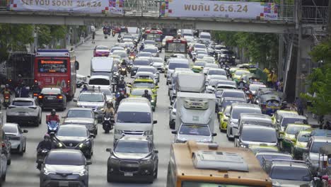 Bangkok's-notorious-traffic,-congested-roads,-dense-clusters-of-cars,-motorbikes-weaving-through-tight-spaces,-and-crowded-intersections,-highlighting-the-city's-bustling-and-chaotic-transport-system