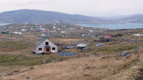 Remote-houses-and-community-nestled-on-rugged-landscape-of-Eriskay-in-the-Outer-Hebrides-of-Scotland-UK