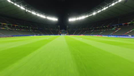 UEFA-EURO2024-Olympic-Stadium-Berlin-FPV-Drone-diving-from-the-night-sky-and-racing-across-the-green-pitch-towards-the-goal