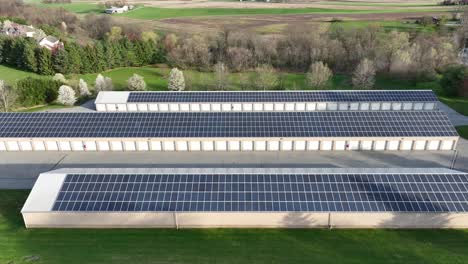 Aerial-lateral-shot-of-solar-panels-on-roof-of-barn-and-stable-of-american-farm