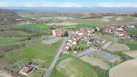 aerial-overview-of-lower-Gabiano,-Italy-with-Church-of-Saint-Peter-Apostle-Catholic-church-as-the-centerpoint