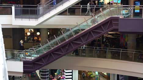 People-taking-the-escalators-up-and-down-during-at-Melbourne-Central-Station,-a-shopping-and-commercial-precinct-in-downtown-area,-showcasing-the-hustle-and-bustle-of-urban-lifestyle