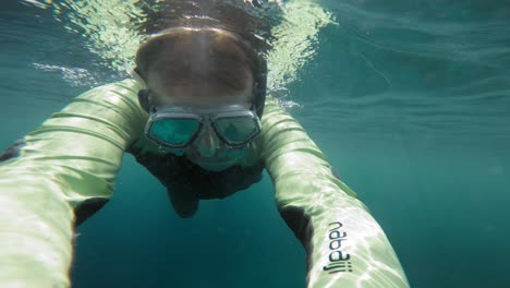 Underwater-selfie-shot-of-a-male-swimmer-in-a-wetsuit