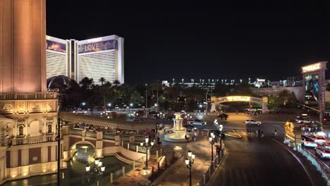 Nighttime-panoramic-scene-of-traffic-and-pedestrian-activity-around-The-Venetian-and-Mirage-Hotel-Resort-and-Casino-along-the-Vegas-Strip,-Nevada,-USA