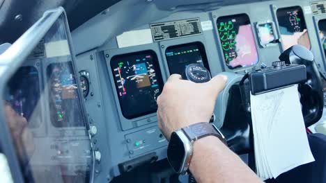 Hand-of-a-white-pilot-piloting-the-flight-controls-of-a-Jet-in-a-real-flight