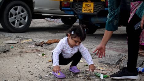 Kid's-mother-stops-her-kid-from-playing-with-the-trash-while-on-vacation