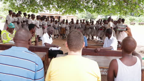 african-young-students-performing-an-indigenous-dancing-ceremony-in-front-of-white-caucasian-politician-leader