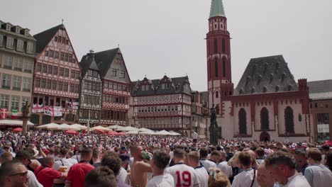 English-fans-crowd-at-Fountain-of-Justice-at-Roemer-during-EURO-Cup-2024-matches-in-Frankfurt,-Germany