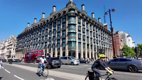 View-of-Westminster-Portcullis-House-office-building-in-London-with-surrounding-traffic-and-pedestrians-on-a-sunny-day