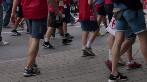 View-of-legs-of-Danish-fans-walking-towards-stadium-for-watching-Denmark-matches-at-EURO-Cup-in-Frankfurt,-Germany