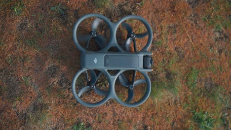 Top-down-view-of-small-FPV-drone-propellers-move-while-turn-on-device
