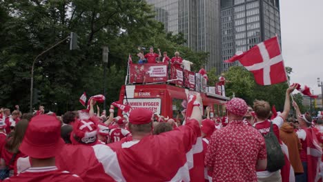 Danish-fans-cheering-and-enjoying-with-Danneborg-bus-at-Frankfurt,-Germany-during-EURO-Cup-matches-on-a-cloudy-day