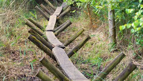 Close-up-view-of-Sweet-Track-neolithic-wooden-plant-walkway-through-peat-wetlands-environment-in-Somerset-Levels,-England-UK