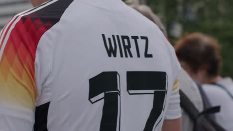 Closeup-shot-of-German-fan-wearing-jersey-of-German-professional-footballer-Wirtz-of-team-number-17-in-Frankfurt,-Germany