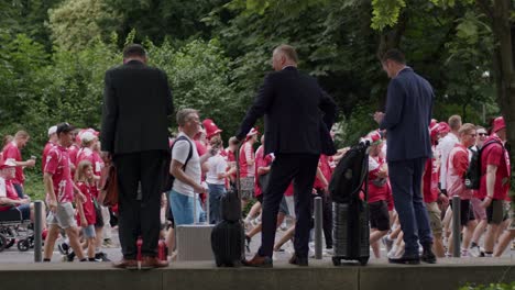 Side-view-of-patriotic-Danish-fans-interacting-with-business-people-in-Frankfurt,-Germany-during-EURO-cup