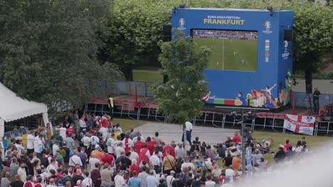 High-angle-shot-of-fans-watching-EURO-Cup-matches-beside-river-Mainufer-in-Germany