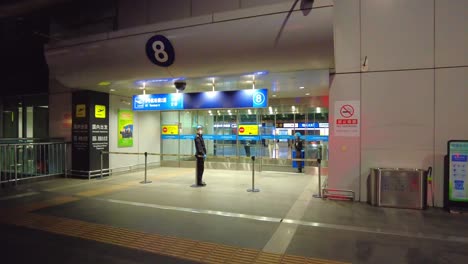 Night-gate-security-at-Beijing-Capital-airport-entrance,-China-during-Covid-19-times