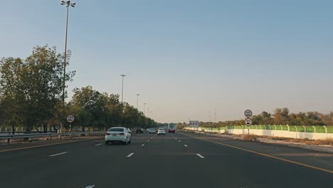 Traffic-navigates-through-Abu-Dhabi-E11-Sheikh-Maktoum-Bin-Rashid-road-towards-Dubai-on-the-third-lane,-which-is-limited-to-drivers-with-a-speed-limit-of-100-km-and-below