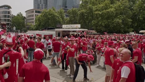 Danish-fans-clicking-pictures-in-front-of-Old-Opera-Place-in-Frankfurt-at-EURO-Cup-2024-in-Germany-during-daytime