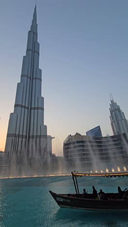 The-world's-tallest-building,-Burj-Khalifa,-set-against-the-dazzling-display-of-the-Dubai-Fountain-show-at-Dubai-Mall,-United-Arab-Emirates