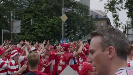 Slowmo-video-of-Danish-fans-cheering-on-street-for-their-team-in-Frankfurt,-Germany