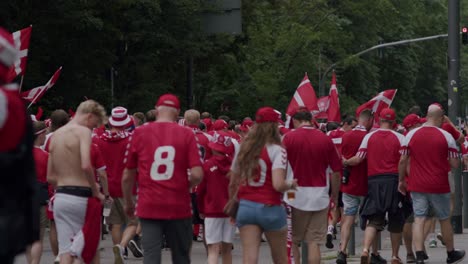 Rear-view-of-Danish-fans-walking-and-cheering-on-streets-of-Frankfurt-during-UEFA-EURO-Cup-2024-in-Germany