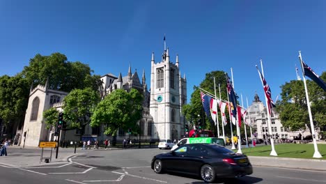 A-beautiful-view-of-St-Margaret's-Church-and-the-Commonwealth-flags-in-Parliament-Square-Gardens-on-a-sunny-day-in-London