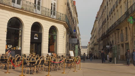 Shot-of-Graslin-Square-with-chairs-on-the-side-walk-in-Nantes,-France