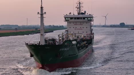 STOC-BALTIC-Chemical-Tanker-Vessel-Sailing-In-The-Hollands-Diep-River-With-Wind-Farm-In-The-Background-In-Moerdijk,-Netherlands