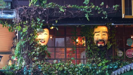 Traditional-Japanese-masks-inspired-lighting-hanging-on-the-exterior-of-restaurant-cafe-at-Jiufen-old-street,-Ruifang-district,-New-Taipei-City,-Taiwan