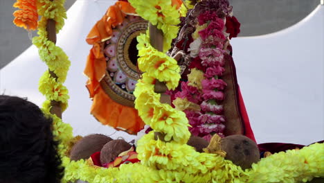 A-murti-statue-of-the-elephant-headed-deity,-Ganesh-is-carried-on-a-palanquin-at-religious-festival