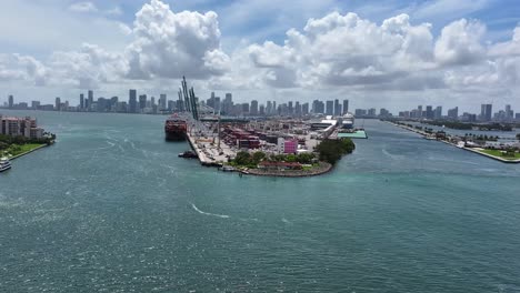 Aerial-approaching-shot-of-industrial-Port-of-Miami,-Florida-with-skyline-in-background