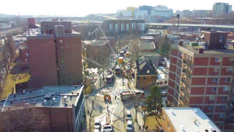 Residential-apartment-fire-with-firefighters-and-Cranes,-Flyover,-Aerial-drone-shot