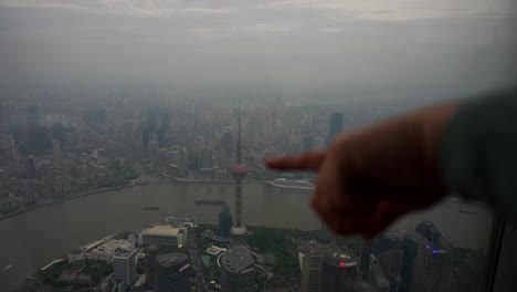 Pointing-to-Oriental-Pearl-Tower-in-Pudong-Financial-District,-Shanghai-Skyline-from-observation-deck