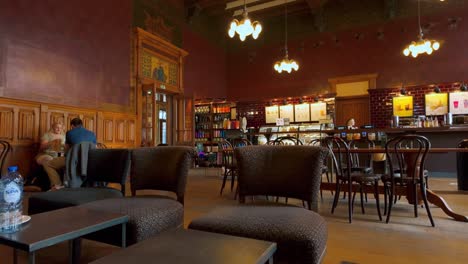 Footage-of-the-interior-of-brown-themed-Starbucks-waiting-room-located-in-Amsterdam-Central-historic-station