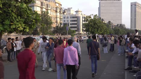 Diverse-crowd-of-people-at-Marine-Drive-beach-sunset-point,-Mumbai-Police-inspecting-tourist-place-Marine-Drive