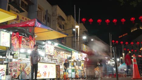 Timelapse-View-Of-bustling-night-market-in-Malaysia-showcasing-an-array-of-shops-and-vibrant-red-lanterns