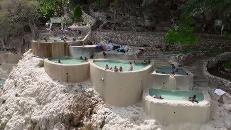 People-relaxing-at-Tolantongo-Hot-Springs-Resort-and-pools,-Mexico